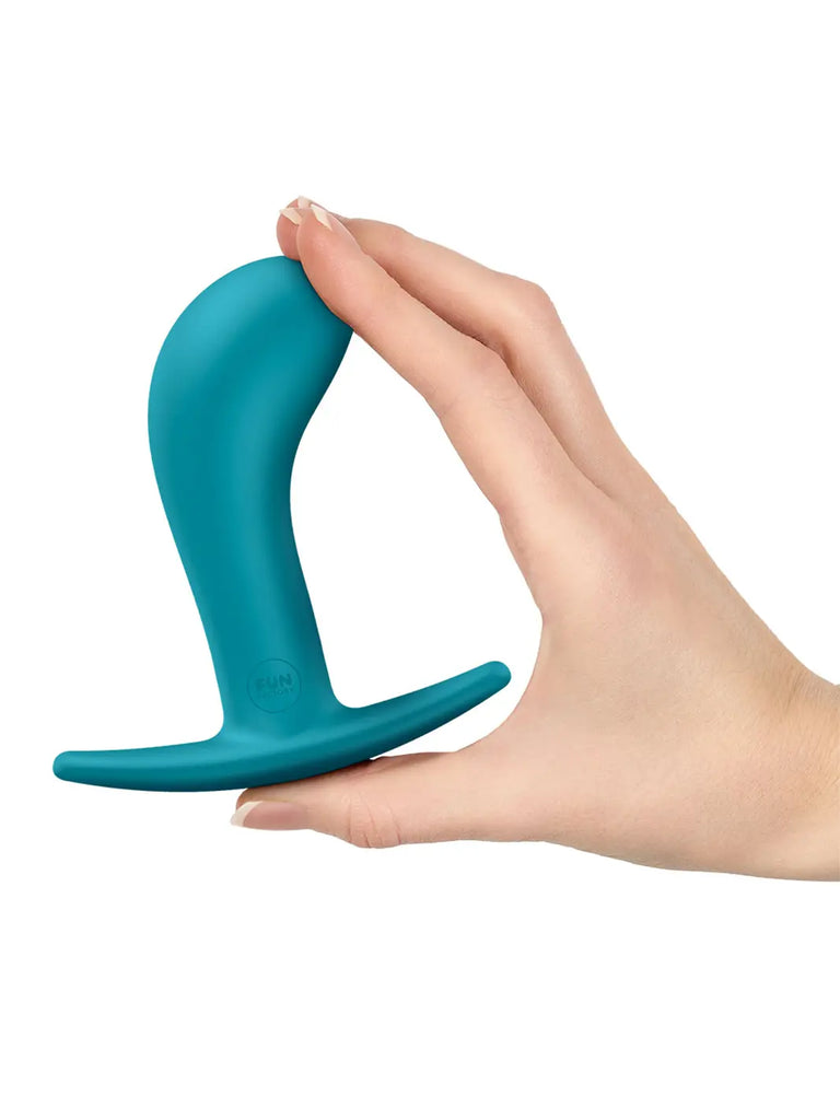 Aquamarine FUN FACTORY Bootie Large held in one hand to show its generous proportions and flexible silicone design