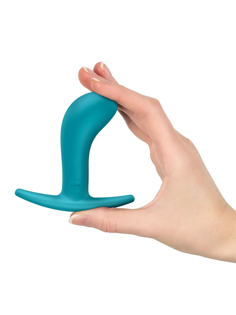 Aquamarine FUN FACTORY Bootie Medium held in one hand to show its proportions and flexible silicone construction