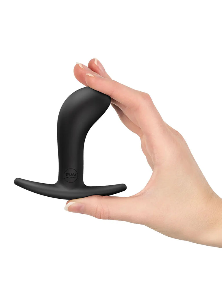 Black FUN FACTORY Bootie Medium held in one hand to demonstrate its medium size and flexible base