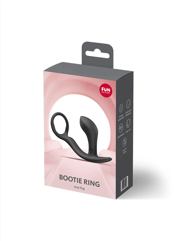 FUN FACTORY Bootie Ring in black shown in hand with compact curved silicone design and flexible ring.