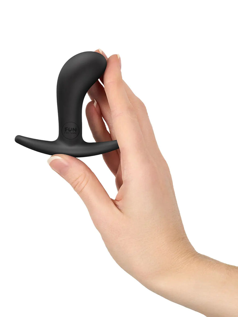 Black FUN FACTORY Bootie Small held in a hand to demonstrate its compact beginner-friendly size