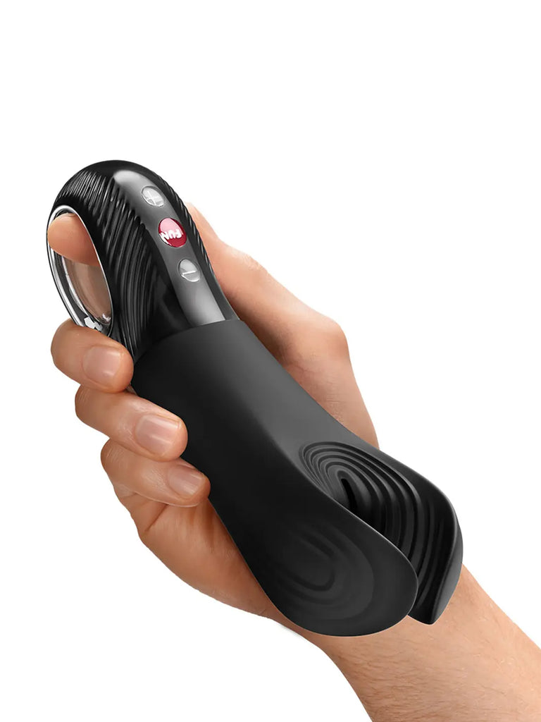 FUN FACTORY Manta in black shown in hand with textured silicone wings and compact handle.