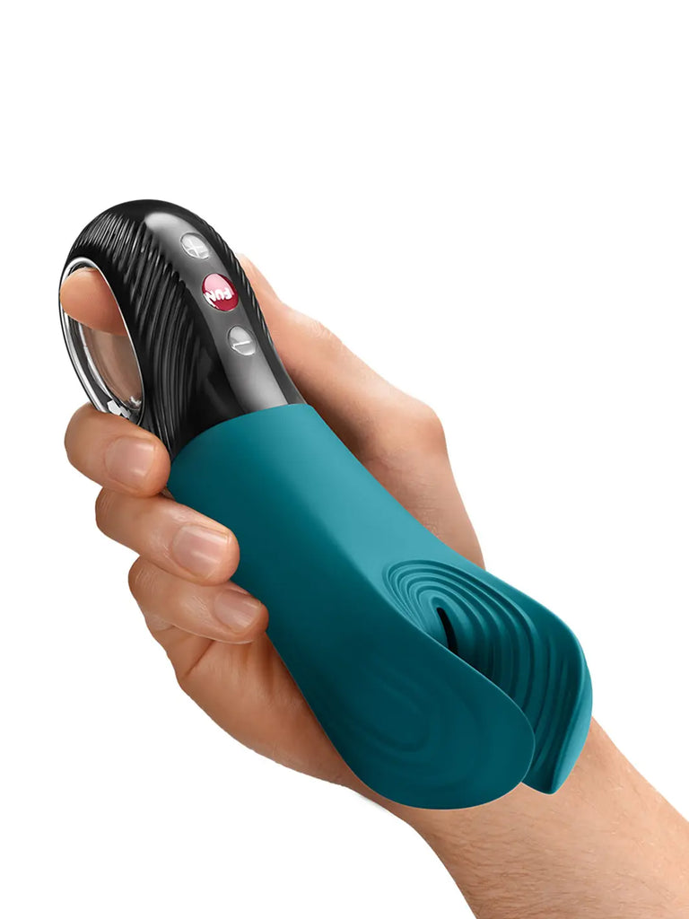 FUN FACTORY Manta in bottle green shown in hand with textured silicone wings and compact handle.
