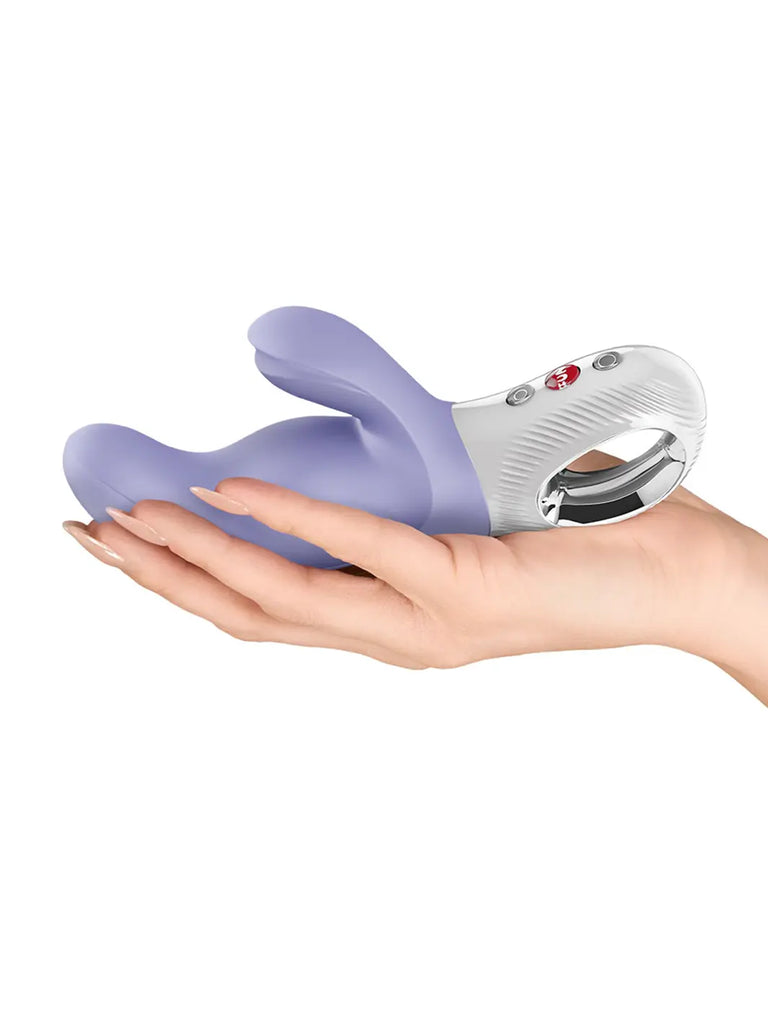 Lilac FUN FACTORY Miss Bi shown in a hand to demonstrate its compact size and flexible construction