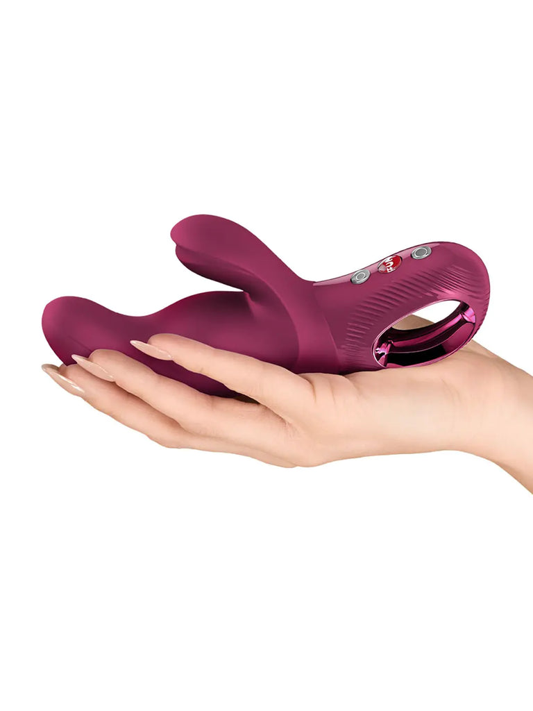 FUN FACTORY Miss Bi in wine red resting in a hand to show its compact curved design